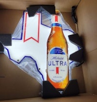 a bottle of ultra beer in a cardboard box